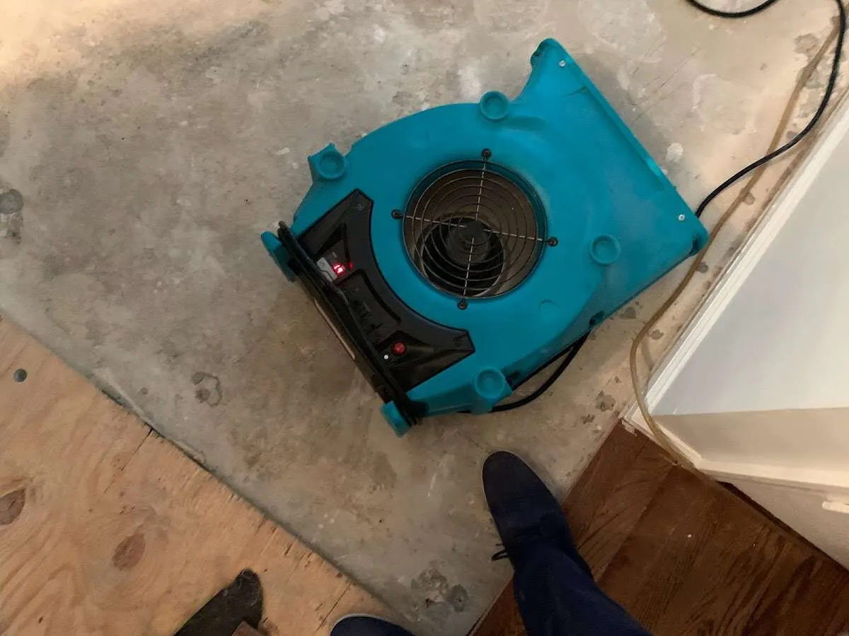 Air mover drying subfloor during Leak Detection & Repair in Ironton